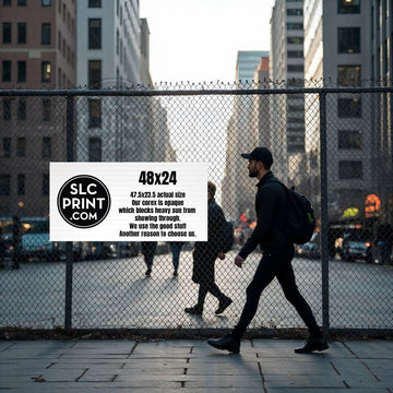 A picture of a custom printed 48x24 coroplast sign attached to a fence with a view of the city in the background.