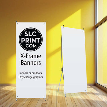 a picture of an X frame banner stand that holds a banner which has a grommet in each corner which is used to connect to the stand. two of them are in a yellow room